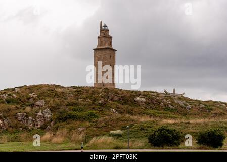 Der Torre de Herkules, ein antiker römischer Leuchtturm und Symbol von La Coruña, Galicien, Spanien, steht hoch vor dem blauen Himmel und bietet einen Blick auf die Stadt Stockfoto