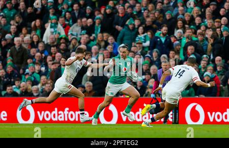 18. März 2023; Aviva Stadium, Dublin, Irland: Six Nations International Rugby, Irland gegen England; James Lowe aus Irland steht unter Druck von Henry Slade aus England Stockfoto