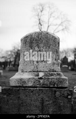 Abgenutzter und verwitterter alter Grabstein mit einer leeren Epitaphe und Platz für Text. Stockfoto