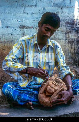 Ein Mann, der Affe auf der Muschel der Kokosnuss schnitzt, Handwerk von Puducherry Pondicherry, Union Territory of India, Asien Stockfoto