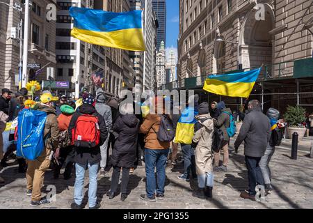 New York, Usa. 19. März 2023. Im historischen Bowling Green Park in Lower Manhattan, New York City, versammeln sich Demonstranten für eine Zeremonie zum Anheben der ukrainischen Flagge, um Solidarität mit dem ukrainischen Volk zu zeigen. Der Internationale Strafgerichtshof (IStGH) hat am Freitag einen Haftbefehl gegen den russischen Präsidenten Wladimir Putin und die russische Amtsträgerin Maria Lvova-Belova wegen eines mutmaßlichen Vorgehens zur Abschiebung ukrainischer Kinder nach Russland ausgestellt. Kredit: SOPA Images Limited/Alamy Live News Stockfoto