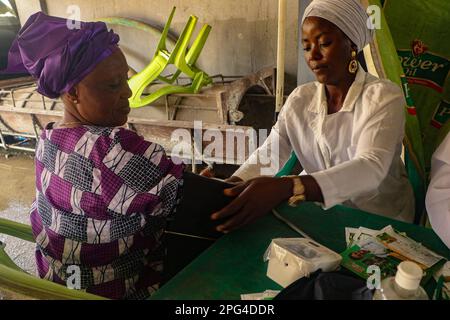 Medizinisches Personal betreut die Frau während einer kostenlosen medizinischen Untersuchung anlässlich des Internationalen Frauentags in der Mobolaji Johnson Arena in Lagos, Nigeria. Stockfoto