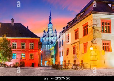 Sighisoara, Rumänien. Mittelalterliche Straße mit Uhrturm in Siebenbürgen. Stockfoto