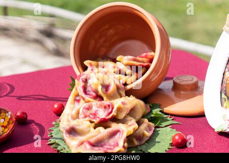 Ukrainische Varenyky mit Kirschen in einer weißen Platte aus weißer Tischdecke. Hartes Licht. Selektiver Fokus. Nahaufnahme Stockfoto