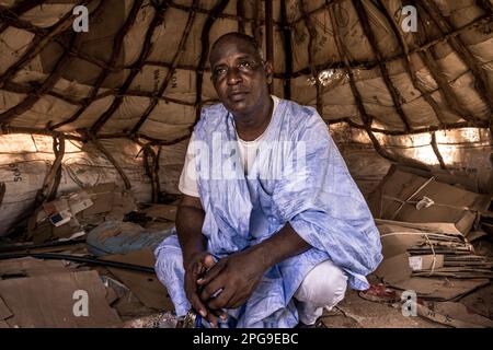 Brahim Ramdhane, ehemaliger Sklave und Gründer seiner NGO Sahel Fondation, zeigt seinem Sohn Ismael das Dorf Ain Salama in der Nähe von Boutilimit in Mauretanien, wo er als Sklave aufwuchs und für seine Master-Familie arbeiten musste. Er kämpft gegen die Sklaverei, gegen die Unterdrückung seines Haratin-Stammes und für faire Bildungsmöglichkeiten, seit er sich als Teenager befreit hat. Stockfoto