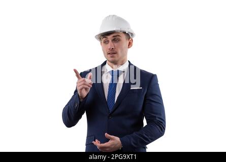 Ein gutaussehender Mann in Anzug und Helm zeigt die Emotionen, Probleme zu lösen, indem er mit dem Zeigefinger zeigt. Konzept im Studio auf weißem Hintergrund. Stockfoto