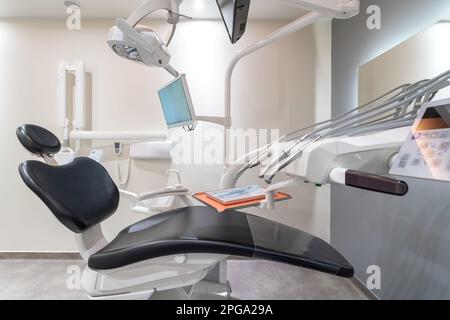Moderne Zahnarztpraxis mit einem Spezialstuhl zur Behandlung von Zahnkrankheiten. Stockfoto