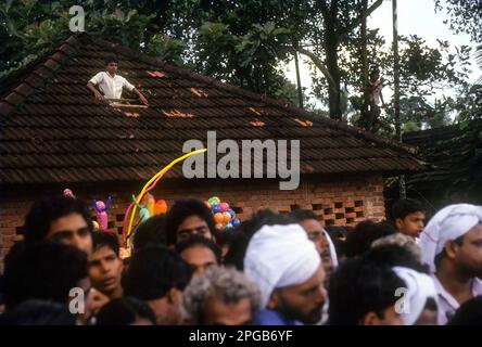 Ein Junge, der das Bootsrennen beim Aranmula Vallamkali Festival oder das Snake Boat Race in Aranmula, Kerala, Indien, Asien beobachtet Stockfoto