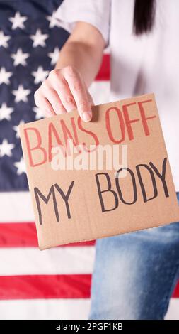 Frau mit einem Schild verbietet My Body amerikanische Flagge auf dem Hintergrund. Protest gegen Abtreibungsverbot. Frauenstreik. Frauen Rechte Freiheit Stockfoto