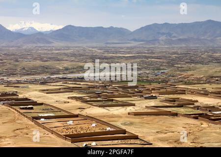 Ein Dorf unter dem Berg in Afghanistan. Ein typischer kleiner Dorfhaufen in der Nähe von Kabul. Stockfoto