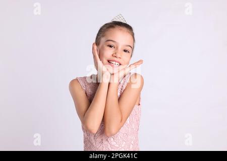 Süßes Mädchen in Diadem auf weißem Hintergrund. Kleine Prinzessin Stockfoto