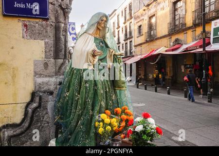 Statue und Schrein des Heiligen Todes, Teil des Santa Muerte-Kult, der von Drogenkartellen verehrt wird, an der Ecke Alhondiga Street und Jesus Maria Street in der Nähe der Zona Centro in Mexiko-Stadt, Mexiko. Der Heilige Tod wird als Mischung aus dem Sensenmann und der Jungfrau von Guadeloupe dargestellt und gilt als mexikanischer Neopaganismus-Volkskult. Stockfoto