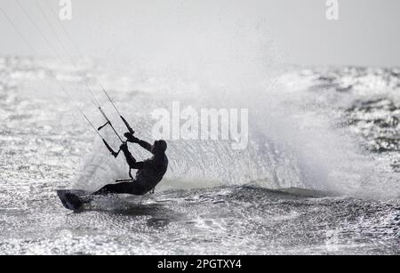 Garrylucas, Cork, Irland. 24. März 2023. Der Drachen-Surfer Ray Kaskelis nutzt eine gelbe Windwarnung, um in Garrylucas, Co. Auf den Wellen zu reiten Cork, Irland.- Kredit; David Creedon / Alamy Live News Stockfoto