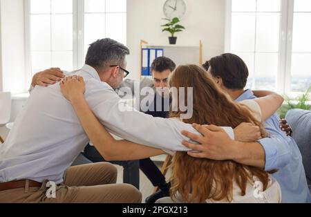 Eine Gruppe von Geschäftsleuten, die sich die Hände auf die Schultern legen Stockfoto