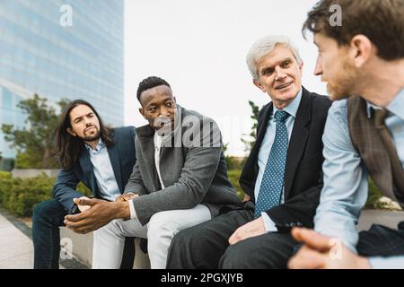 Ein Team von Geschäftsleuten verschiedener Rassen mit unterschiedlichen Alters und ethnischen Zugehörigkeiten, die sich außerhalb des Büros treffen Stockfoto