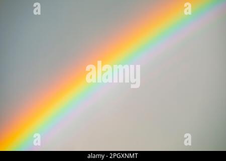 Nahaufnahme des leuchtenden, hellen Regenbogens am Himmel. Regenbogenstruktur. Stockfoto