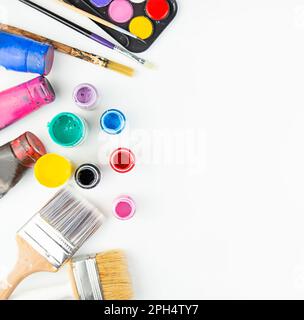 Aquarellfarben und Pinsel zum Malen auf einem weißen Tisch. Flach verlegt. Speicherplatz kopieren. Stockfoto