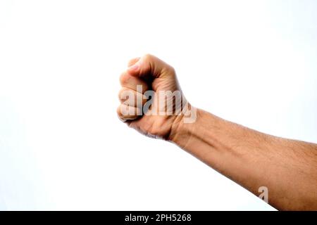 Geballte Faust eines Menschen auf weißem Hintergrund. Stockfoto