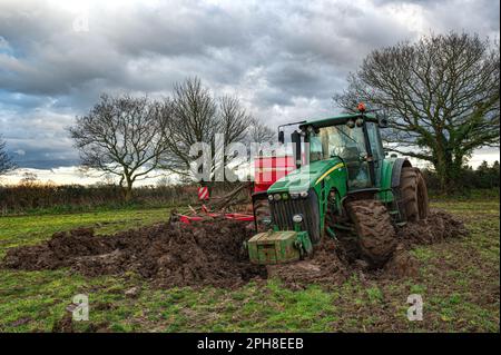 Großer John Deer-Traktor und -Bohrer wurden aufgegeben, nachdem er auf dem Ackerland von North Norfolk, Großbritannien, feststeckte Stockfoto