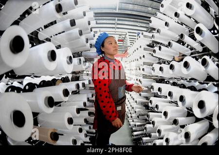 LIANYUNGANG, CHINA - 27. MÄRZ 2023 - Ein Arbeiter stellt Textilerzeugnisse an einer Produktionslinie in einem Privatunternehmen in Lianyungang Economic und Technol her Stockfoto