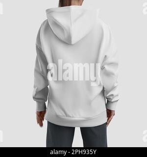 Modell eines langen weißen Hoodies auf einem Mädchen, übergroßes Damenshirt, Langarm für Design, Branding, Werbung. Straßenbekleidung, modische Sweatshirt-Templat Stockfoto