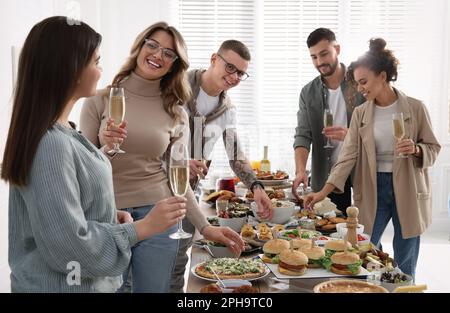 Eine Gruppe von Personen, die ein Brunch-Buffet zusammen im Haus genießen Stockfoto