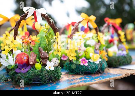 Wunderschöne Osterdekoration in traditionellen Frühlingsfarben mit Ostereiern, Hasen dekoriert mit Frühlingsblumen - goldener Regen und Primrose verkauft an Stockfoto