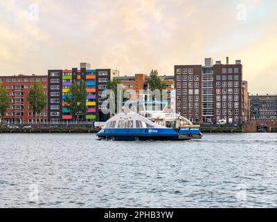 Fähre und Wohngebäude auf der Insel Java im östlichen Hafengebiet von Amsterdam, Niederlande Stockfoto