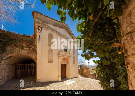 Manta, Cuneo, Piemont, Italien - 27. März 2023: Die antike Pfarrkirche Santa Maria am Schloss Manta (15. Jahrhundert) auf dem Hügel Stockfoto