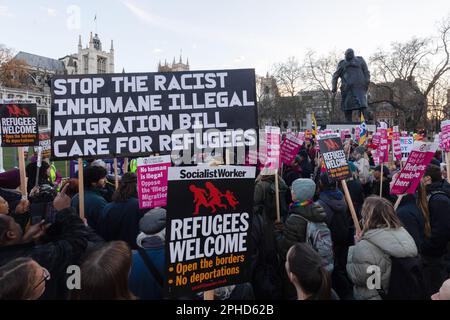 London, Großbritannien. 27. März 2023. Demonstranten halten während einer Kundgebung vor den Parlamentsgebäuden über das Gesetz gegen die Einwanderung Plakate, auf denen sie ihre Meinung zum Ausdruck bringen. Kredit: SOPA Images Limited/Alamy Live News Stockfoto