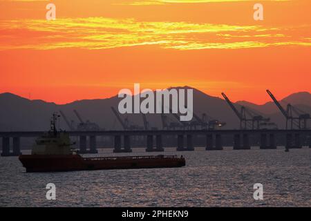 Silhouette der Kräne am Pier am Abend. Stockfoto