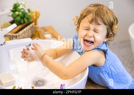 Das Kind wäscht seine Hände mit Seife. Selektiver Fokus. Kleiner. Stockfoto