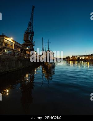 Das MV Balmoral Schiff an der Princes Wharf in Bristol kurz nach Sonnenuntergang, mit den Lichtern der Anlegestelle und der Stadt im Wasser. Stockfoto
