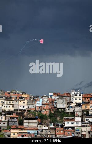 Drachen fliegen über Morro do Timbau, einer der Gemeinden, die Favela da Maré bilden, einer der größten Slum-komplexe in Rio de Janeiro, eine Folge der niedrigen Indikatoren für soziale Entwicklung, die die nördliche Region der Stadt charakterisieren. Stockfoto