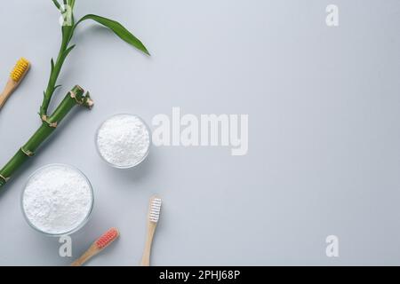 Zahnpulver, Bürsten und Bambusstiel auf weißem Hintergrund, flach liegend. Platz für Text Stockfoto