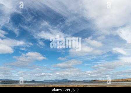 Großer weißer Himmel in einer Landschaftsszene mit Austernrahmen bei Ebbe in Tasmanien. Himmelsersatz. Stockfoto