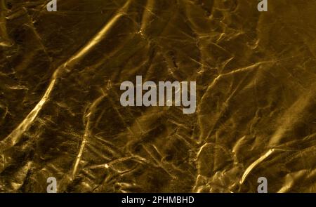 Texturhintergrund aus zerknittertem Gold, Bronzemuster, edles gelbes Modell mit Metallic-Effekt und Kopierbereich Stockfoto