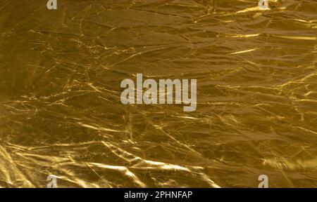 Texturhintergrund aus zerknittertem Gold, Bronzemuster, edles gelbes Modell mit Metallic-Effekt und Kopierbereich Stockfoto