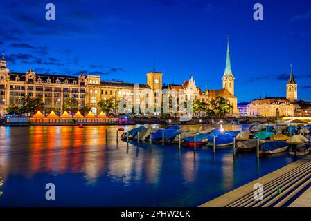 Blick auf den Sonnenuntergang über das historische Stadtzentrum von Zürich mit der berühmten Fraumünsterkirche und dem Fluss Limmat an einem sonnigen Tag in der Schweiz. Stockfoto