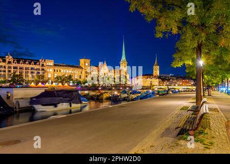 Blick auf den Sonnenuntergang über das historische Stadtzentrum von Zürich mit der berühmten Fraumünsterkirche und dem Fluss Limmat an einem sonnigen Tag in der Schweiz. Stockfoto