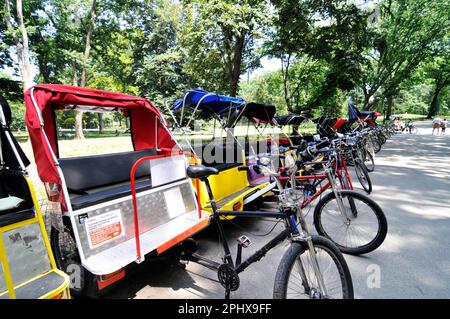 Fahrradrackshaws parken am Eingang des Central Park in New York City, NY, USA. Stockfoto