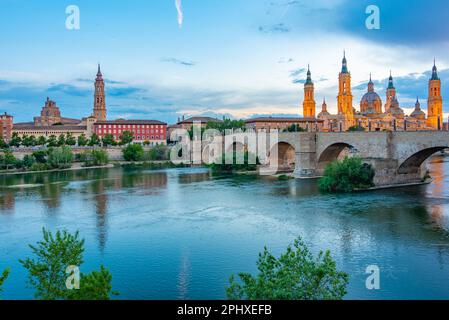 Nachtsicht auf die Basilika de nuestra senora de pilar, catedral del salvador de zaragoza und puente de piedra in Saragoza, Spanien. Stockfoto