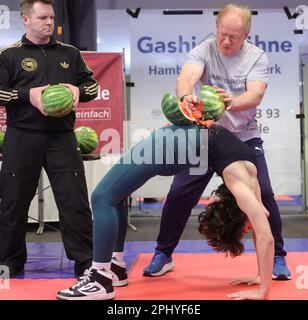 Hamburg, Deutschland. 30. März 2023. Mit seiner Hand schlägt Muhamed Kahrimanovic im Platteninstitut für Deutschland in einer Minute 16 Wassermelonen auf Lucrezia Albanes Bauch und setzt damit einen Weltrekord. Kredit: Ulrich Perrey/dpa/Alamy Live News Stockfoto