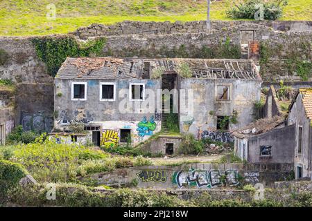 Europa, Portugal, Porto. 6. April 2022. Verfallenes Steinhaus mit Graffiti bedeckt. Stockfoto