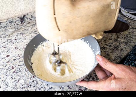 Elektrischer Mischer zur Zubereitung von Käsekuchen-Zutaten. Familiengastronomie. Stockfoto