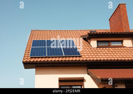 Haus mit installierten Sonnenkollektoren auf dem Dach. Alternative Energie Stockfoto