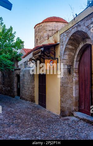 Rhodos, Griechenland, 25. August 2022: Sonnenaufgang auf einer historischen Straße im Zentrum von Rhodos, Griechenland. Stockfoto