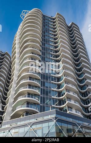 Ein Hochhaus am blauen Himmel. Wohnungs- oder Apartmentgebäude. Man Blickt Auf Das Blaue Moderne Gebäude. Architektur im modernen Gebäude GLA Stockfoto