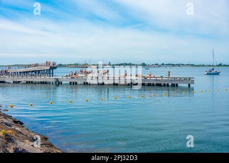 Varberg, Schweden, 12. Juli 2022: Sonnenbaden auf einem Pier in der schwedischen Stadt Varberg. Stockfoto