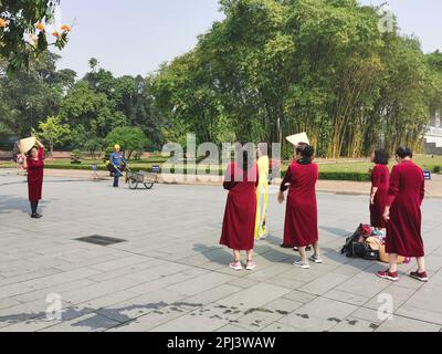 Hanoi, Vietnam. 27. Februar 2023. Frauen in traditionellen Kleidern machen Fotos von sich in der Nähe des Ho Chi Minh Mausoleums auf dem Ba Dinh Platz. Kredit: Alexandra Schuler/dpa/Alamy Live News Stockfoto